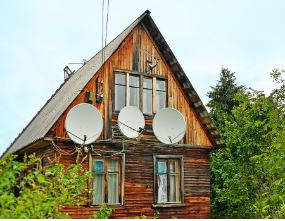 Rustic Home With Satellite Dishes Mounted