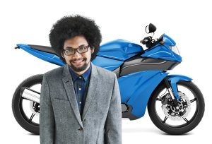 Man Standing In Front Of Blue Motorcycle
