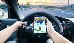 Person Playing Pokemon Go While Driving